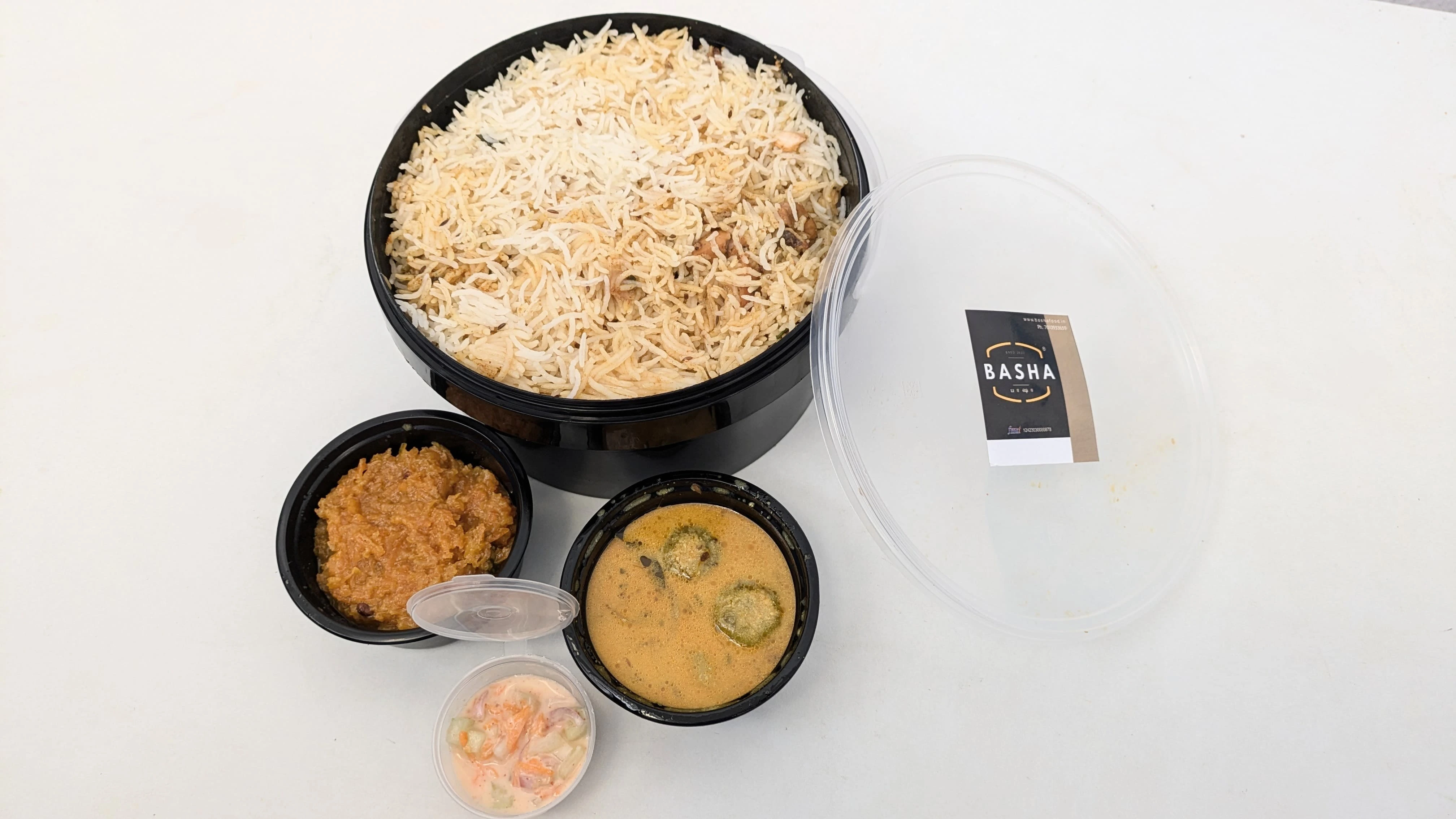 A Family pack of Hyderabad Chicken Biriyani with various side dishes